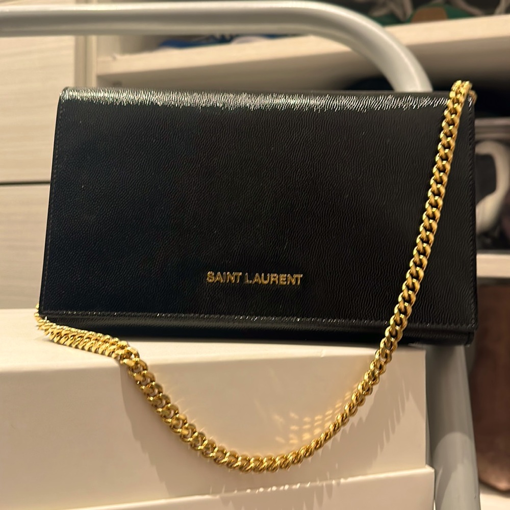 Yves Saint Laurent Black clutch/evening bag with gold chain.